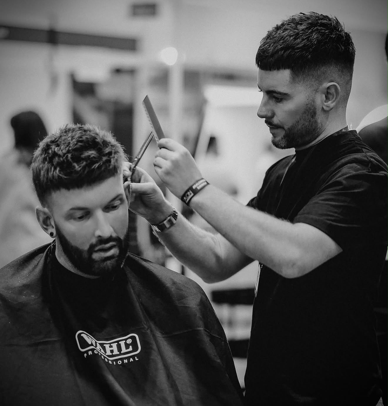 Tom Walker fitting and cutting a client's hair system